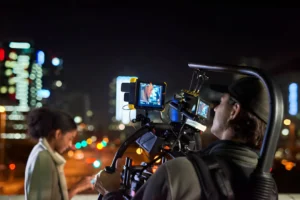 Hombre grabando a una mujer en una ciudad